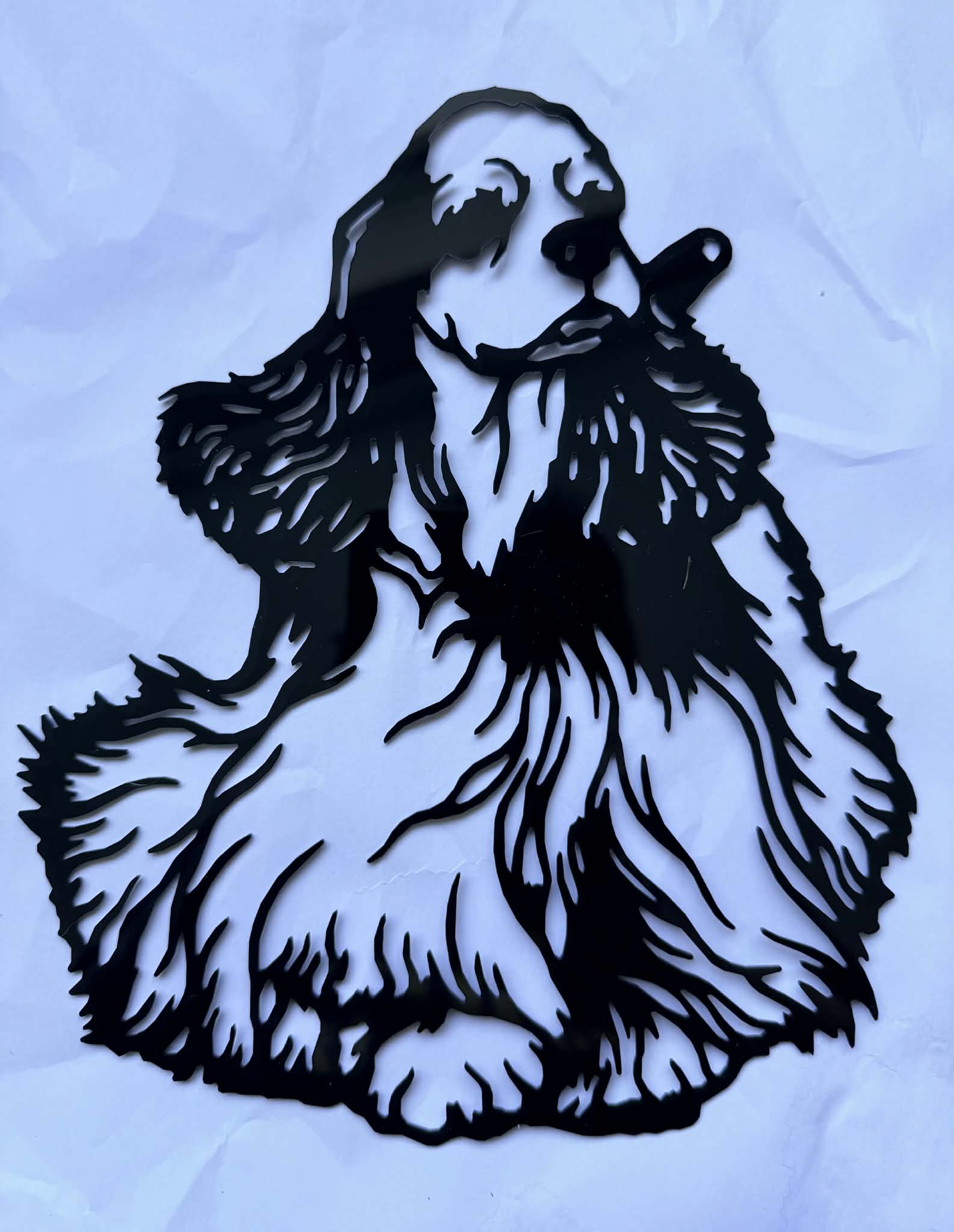 Black acrylic laser-cut piece of the same cocker spaniel with detailed flowing coat